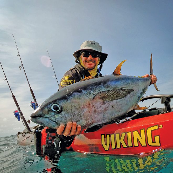 A man is fishing on a boat with a spinning rod. Tuna hunting